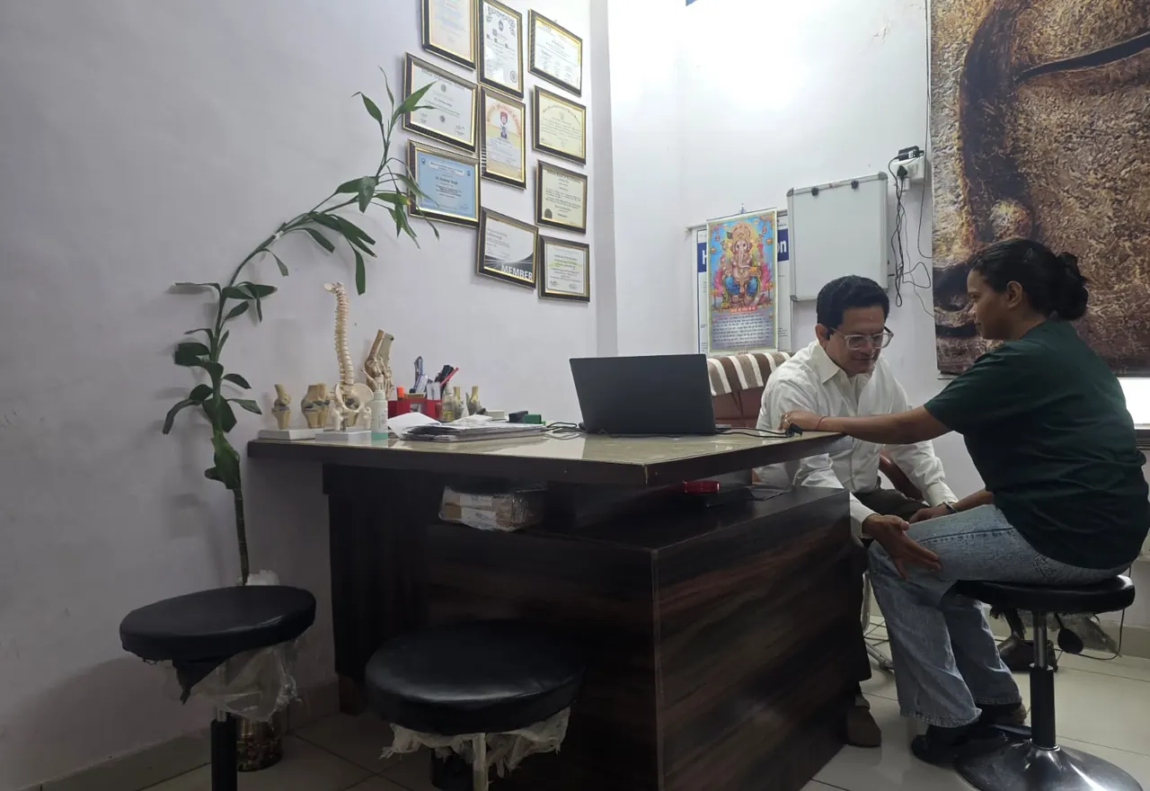 Dr. Kuldeep Singh assessing the hip area during a consultation